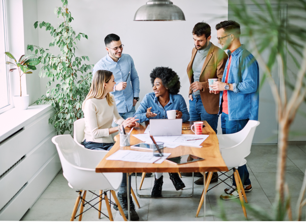 Diverse professionals discussing around a table in an office.